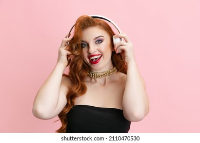 Lead Singer, Soloist, Performer. Young Beautiful Talanted Woman In Headphones Isolated Over Pink Background. Concept Of Art, Music, Jazz, Concert, Inspiration, Culture. Copy Space For Ad