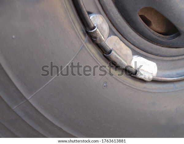 Lead weight on car rims. Lead-weighted wheel\
balancing for vehicle wheel balance while in use with copy space.\
Focus close and choose the\
subject.