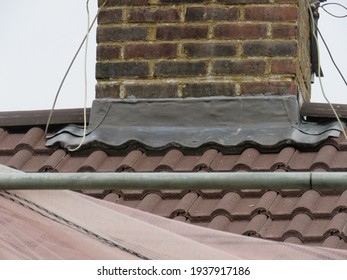 Lead work at the base of a brick chimney stack