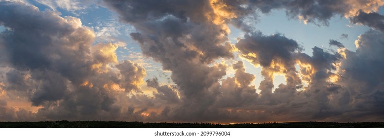Leaden, storm clouds covered the sunset. Cumuliform cloudscape on blue sky. Tragic gloomy sky. - Shutterstock ID 2099796004