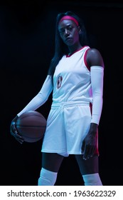 Leader. Beautiful African-american Female Basketball Player In Motion And Action In Neon Light On Black Background. Concept Of Healthy Lifestyle, Professional Sport, Hobby. Woman In Sport.