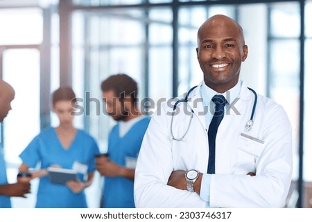 Leader, man and portrait of doctor in hospital, healthcare or clinic with medical expert nurses to trust in quality care. Black man, medicine and happy neurosurgeon with arms crossed in confidence