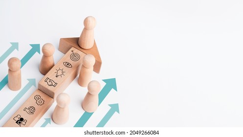 The leader, wooden figure leading the team with business icon on wood block with heading arrows on white background with copy space. Business strategy with growth success process, leadership concept. - Powered by Shutterstock