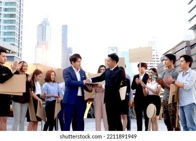 Leaders Making Agreements And Shaking Hands With Crowds Of People Hold Blank Banners Placards Protesting At City As Background, Group Of Rebellions Protester Calming Down After Reaching Consensus.