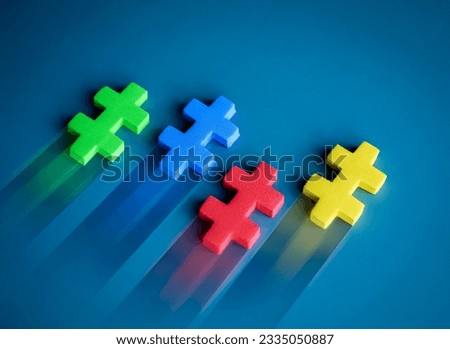 Leadership, business game competition, winner, difference, teamwork, partnership, challenge, and motivation concepts. Four multi-color puzzle pieces moving fast in competition on blue background.