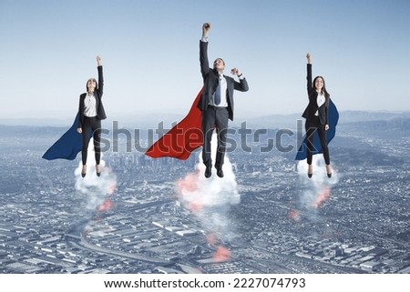 Leadership, business success and ambition concept with women and man in superman coats taking off from megapolis city on blue sky background