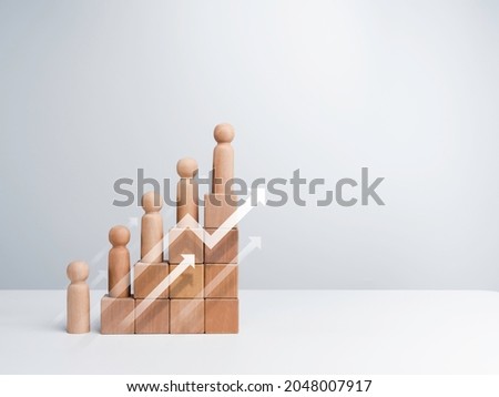 Leadership with business success concept. Modern rising up arrows and wooden figures standing on a growth graph chart steps arranged by wood cube blocks isolated on white background with copy space.