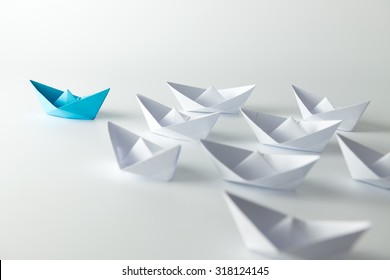 Leadership Concept With Blue Paper Ship Leading Among White