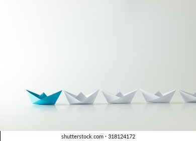 Leadership Concept With Blue Paper Ship Leading Among White