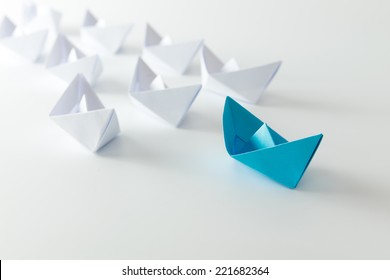 Leadership concept using blue paper ship among white - Shutterstock ID 221682364