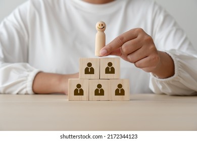 Leadership Concept Using Wooden Figures Faceless Human And Blocks. Leader At Top Picking By Woman Hand. Hiring Employee For Organization.