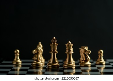 Leadership. gold queen with silver chess pieces on chess board game competition on dark background, chess battle, team leader, teamwork and business strategy concept,victory, success, management