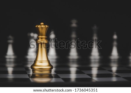 Leadership. gold queen with silver chess pieces on chess board game competition on dark background, chess battle, victory, success, management, team leader, teamwork and business strategy concept