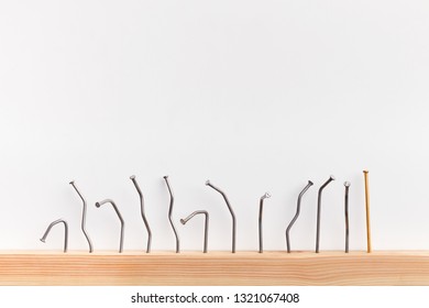 Leadership and power of individuality. Straight golden nail with row of bent ones, isolated on white, free space