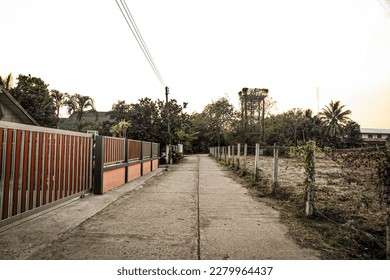 Leading line of concrete road with power lines - Powered by Shutterstock