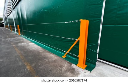 Leading Lines View. Yellow Steel Pole There Is Rope Sling Attach To The Fence Line. For Protecting The Wall Tent Of Factory.