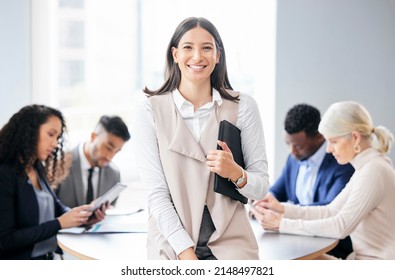 Leading My Team To Greatness. Shot Of A Young Businesswoman In A Meeting With Her Colleagues.