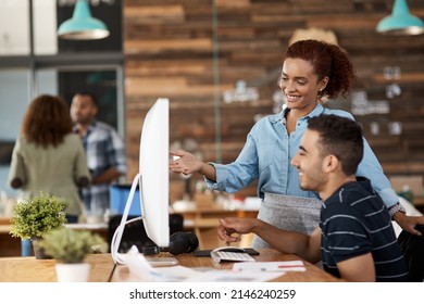 Leading The Way With Their Creative Expertise. Shot Of Two Young Designers Working Together On A Computer In An Office.