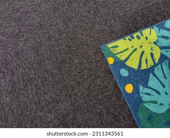 A leaf pattern floor rug on top grey carpet - Shutterstock ID 2311343561