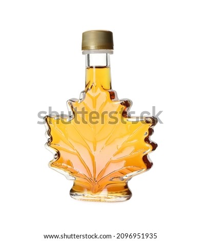 Leaf shaped bottle of delicious maple syrup isolated on white