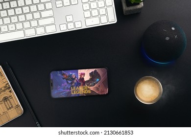 League of Legends (LOL) mobile game app on the smartphone screen on black background table with a coffee, computer and Alexa on the side. Office environment. Rio de Janeiro, RJ, Brazil. February 2022.
