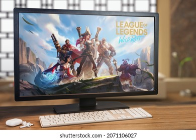 League of Legends Wild Rift game on computer screen. Monitor, keyboard and airpods on wooden table. Selective focus. Rio de Janeiro, RJ, Brazil. October 2021.