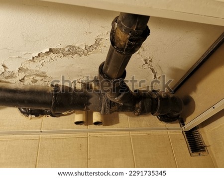a leak on an old damaged sewer pipe. broken sewerage cast iron  pipe