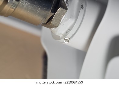 Leakage Heating System. Problem With Water Leakage At The Junction Of Pipes And Radiators Of The Home Heating System. Water Leakage With Poor Tightness Of Threaded Pipe Connections. Selective Focus