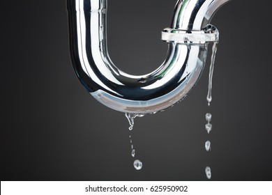 Leakage Of Water From Stainless Steel Pipe On Gray Background