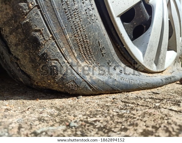 a leaking\
car tire shot in detail and low\
angle