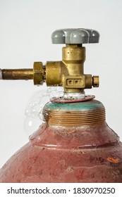 Leaking gas cylinder for industrial welding with dial, valve and nozzle