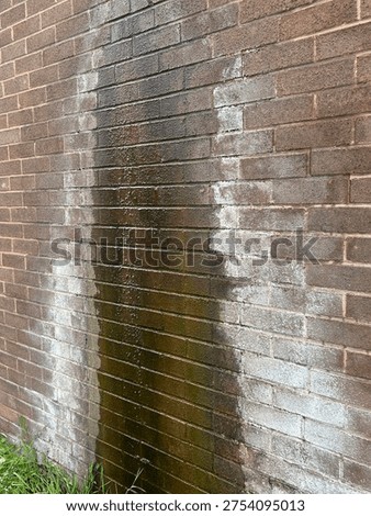 Leaking Gutter Drip Causing Water Stains and Efflorescence on Exterior Brown Brick Wall, Damp Wall