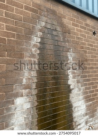 Leaking Gutter Drip Causing Water Stains and Efflorescence on Exterior Brown Brick Wall, Damp Wall