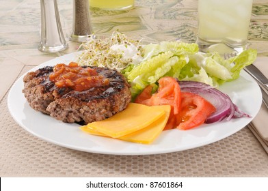 A Lean Broiled Ground Beef Patty With Alfalfa Sprouts, Cheese And Salad