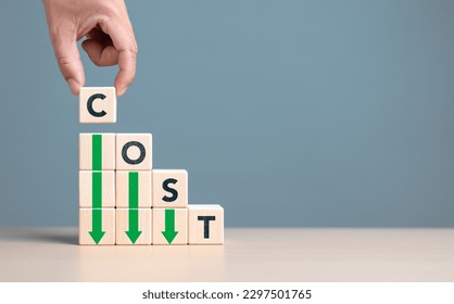 Lean or Cost reduction concept. Optimize manufacturing management. Decreasing company expense to maximize profits. Hand puts wooden cube with words cost and green down arrows. Business improvement.