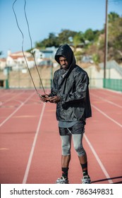 Lean Jamaican Athlete Swinging Skip Rope For Rhythm On Track At Stadium. 