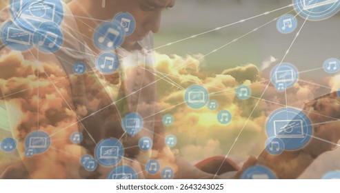 Leaning forward man in casual tee interacting with smartphone in cloud network, floating icons. Technology, connectivity, innovation, communication, digital, futuristic, business