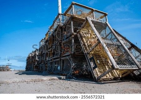 Leaning stack of atlantic lobster traps at the pier on a summer day, waiting for the next fishing season, Nova Scotia Canada