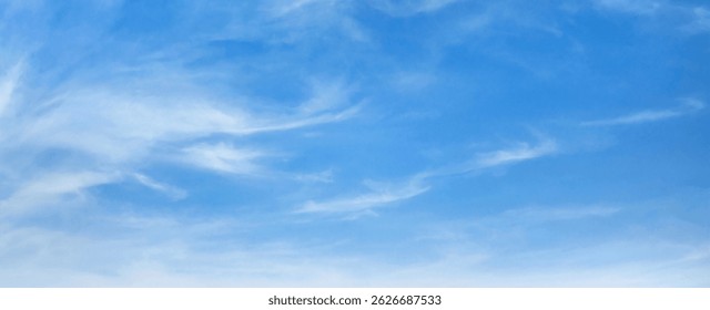 lear blue sky with clouds. The sky is very bright and the sun is shining. The sky is very open and there is no sign of any weather