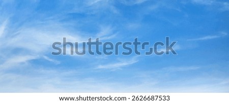lear blue sky with clouds. The sky is very bright and the sun is shining. The sky is very open and there is no sign of any weather