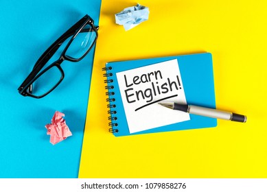 Learn English - Note At Blue And Yellow Background With Teachers Glasses