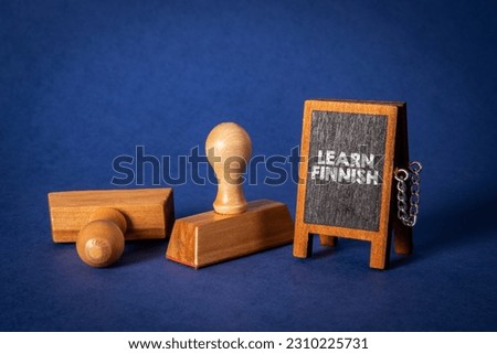 Learn Finnish. Miniature chalkboard with text. Wooden stamps.