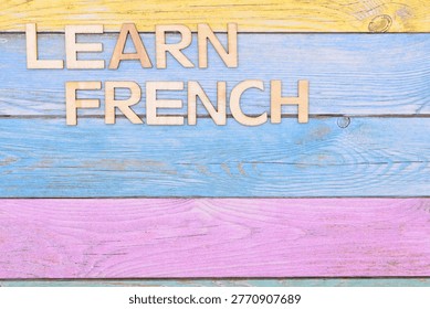 learn french write on rustical wooden background 