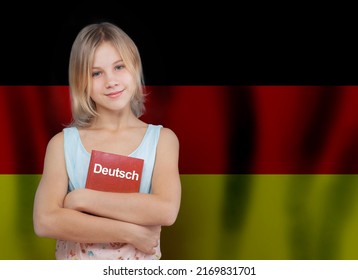 Learn German language concept. Beautiful young girl holding book with inscription German in German language on flag of Germany background