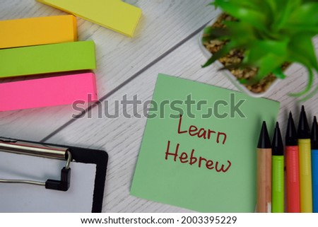 Learn Hebrew write on sticky notes isolated on Wooden Table.