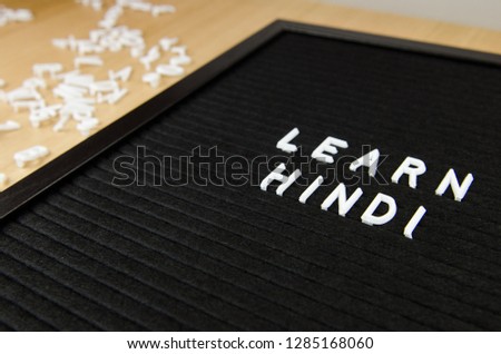 learn Hindi language sign on black background