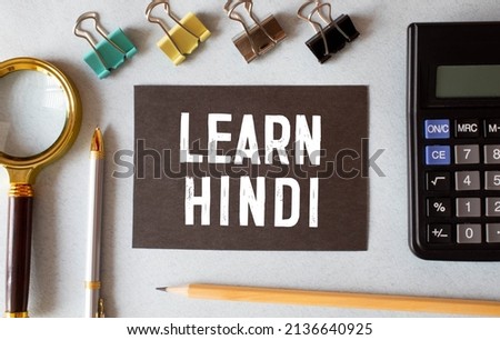 learn Hindi language sign on black background.