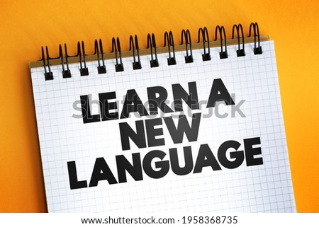 Learn A New Language text quote on notepad, concept background