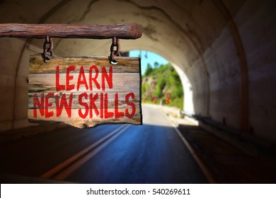 Learn New Skills Motivational Phrase Sign On Old Wood With Blurred Background