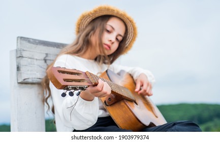 Learn To Play The Guitar Diligently. Girl Enjoy The Moment. Have Fun On Celebration. Kid Singing With Guitar. Teen Hipster Playing On Guitar. Singer With Acoustic Guitar. Music And Art. Musical Shop.